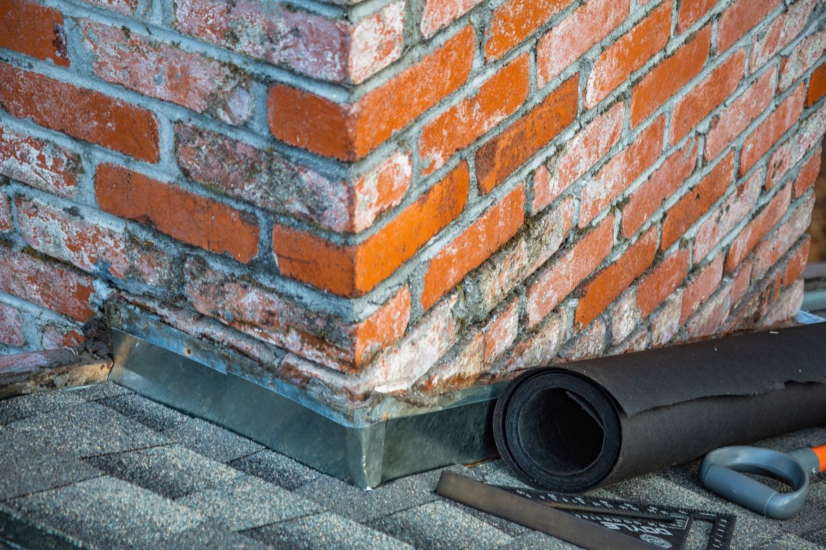 Chimney flashing and mortar repair in progress